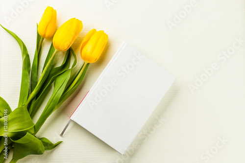 book and yellow tulips