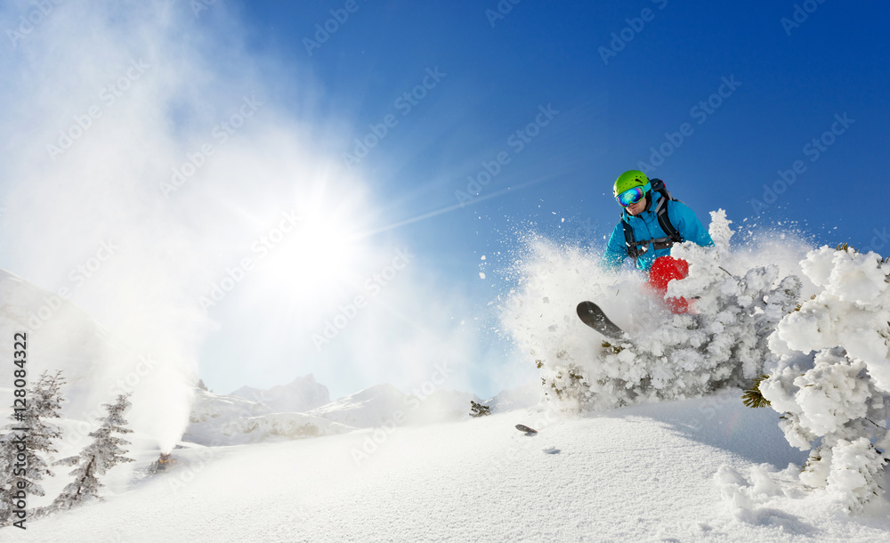 Freeride skier on piste running downhill