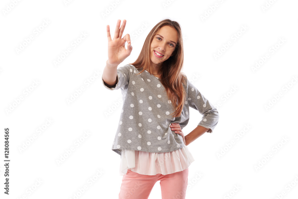 Beautiful young girl in trendy casual clothes showing ok gesture Beautiful young girl in trendy casual clothes showing ok gesture