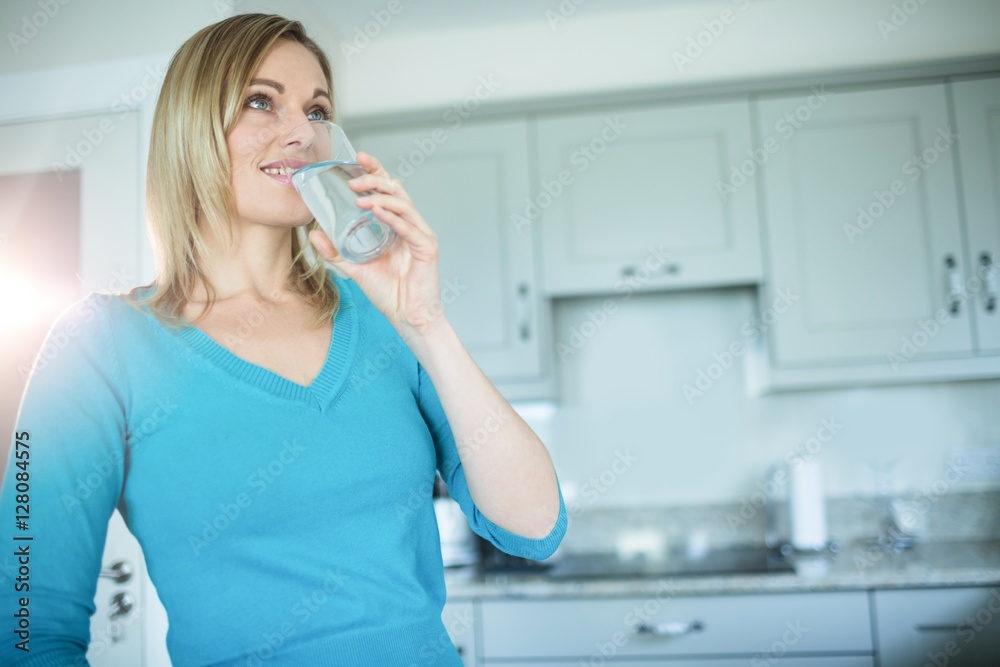 Pretty blonde woman drinking a glass of water Pretty blonde woman drinking a glass of water