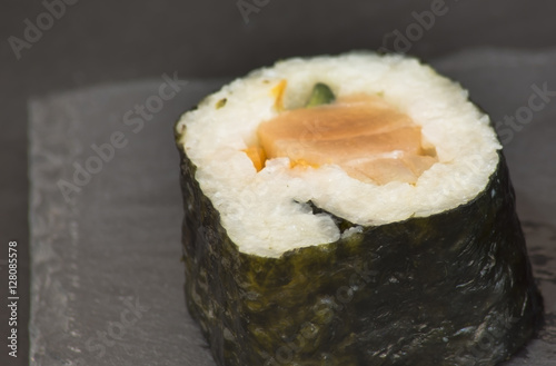 Pieces of sushi on a black stone photo