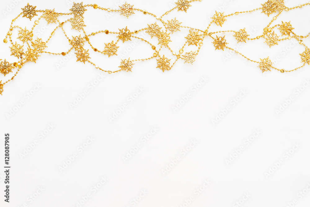 Clear white background with border of golden chain with snowflakes. Christmas and New Year holiday background with place for text. Flat lay, top view. Clear white background with border of golden chain with snowflakes. Christmas and New Year holiday background with place for text. Flat lay, top view.