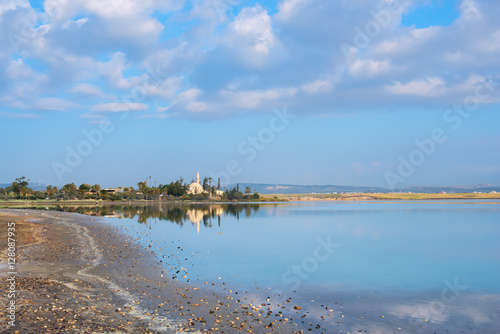 Mosque on the background of colorful clouds and lake