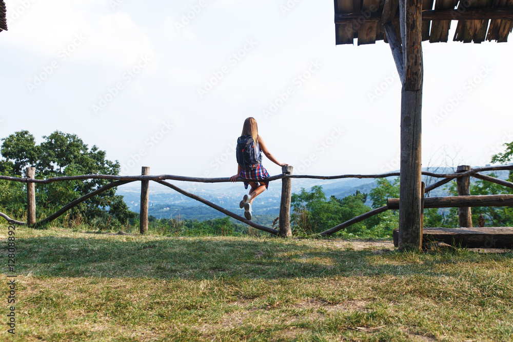 Young female hiker with backpack and map with open arms. Young female hiker with backpack and map with open arms.