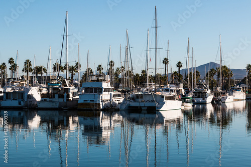 Boats moored in bay at the Chula Vista Bayfront park with mountain peak in the background.