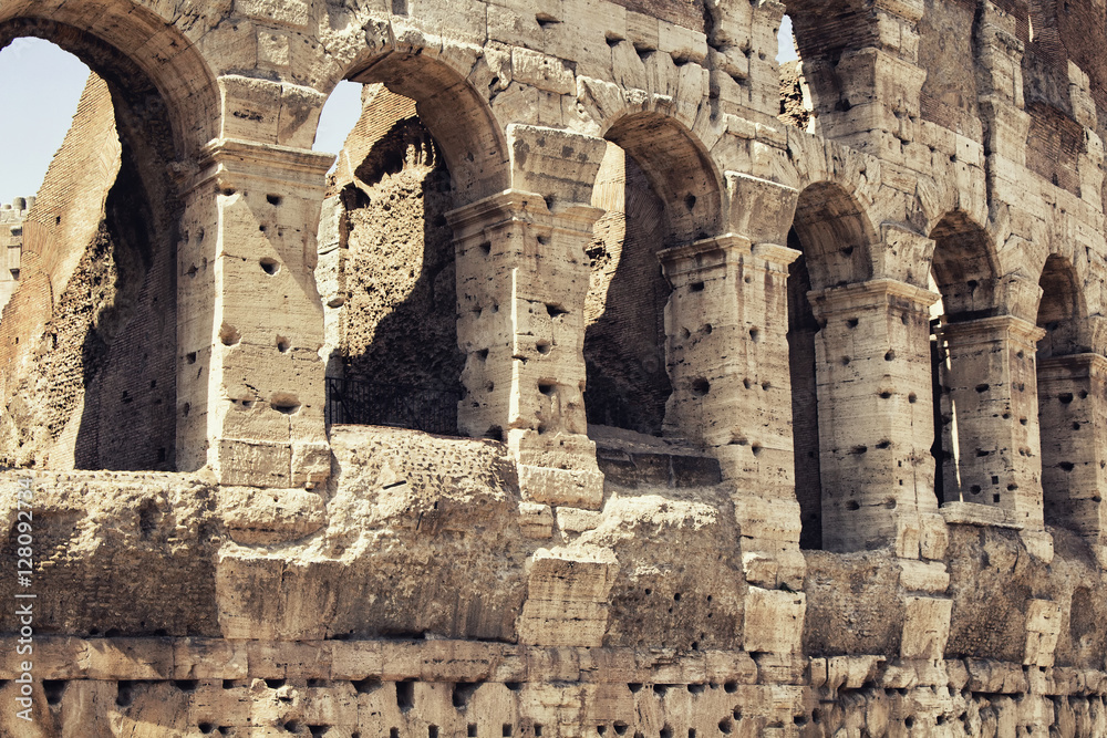 Close up view of Colosseum in Rome. Monumental 3-tiered Roman amphitheater once used for gladiatorial games.
