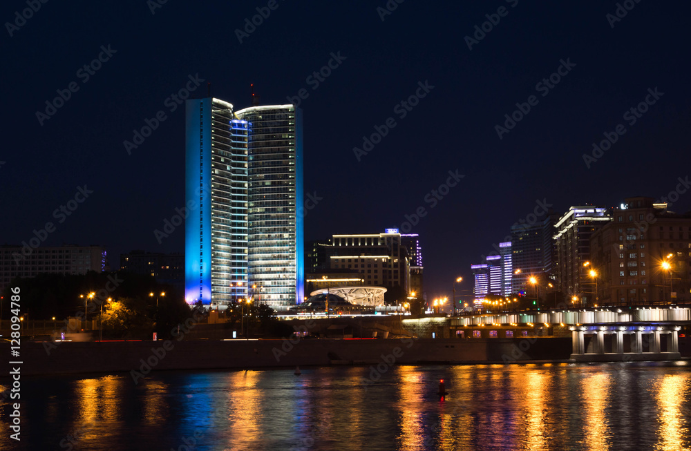 house with blue illuminated on river bank