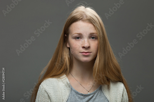 Human face expressions and emotions. Portrait of young adorable redhead woman in cozy shirt looking calm and happy.