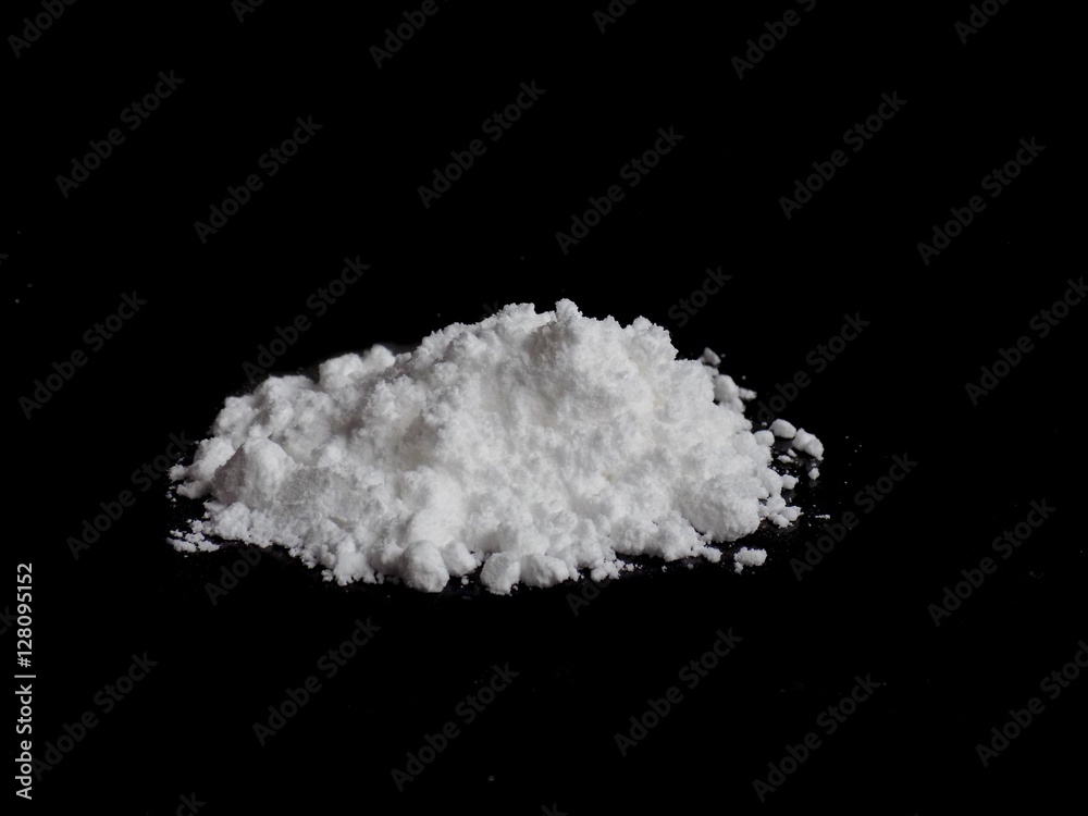 Cocaine drug powder pile on black background Cocaine drug powder pile on black background