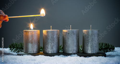 Light four advents candles with matches