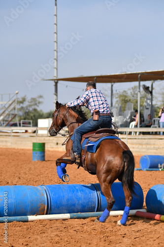 Cowboy jumping over barrels during the competition "Cowboy Extreme"