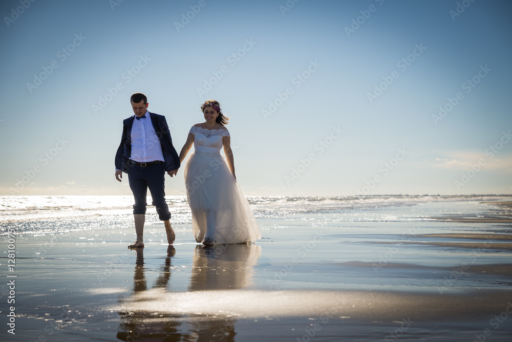 Bride and groom in honeymoon in Italy, Trash the Dress, Bibione Beach, Couple in love, Romantic playful Bride and groom in honeymoon in Italy, Trash the Dress, Bibione Beach, Couple in love, Romantic playful