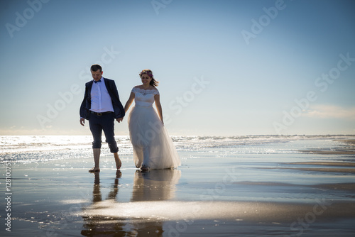 Bride and groom in honeymoon in Italy, Trash the Dress, Bibione Beach, Couple in love, Romantic playful © icephotography