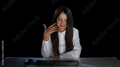 Girl shyly looking at the monitor computer. Emotions. Studio photo