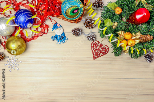 Christmas background with spruce tree, snowflakes and balls on table. Top view