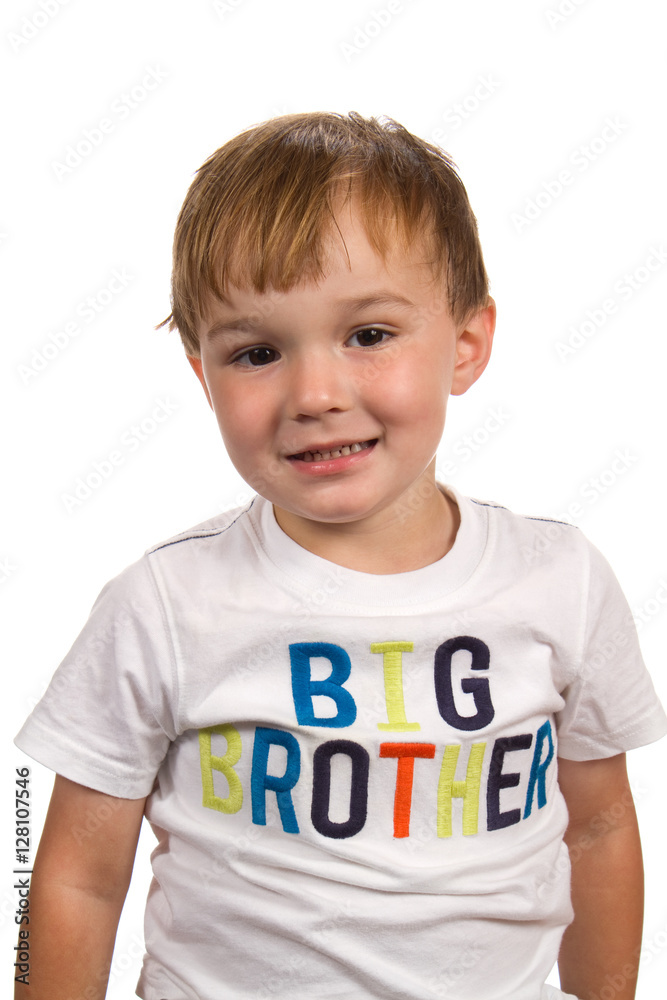 Cute little boy smiles while wearing a t-shirt signifying the he is the big brother. Cute little boy smiles while wearing a t-shirt signifying the he is the big brother.