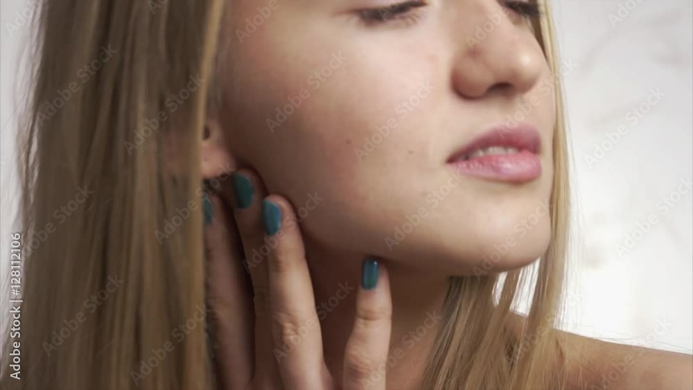 Young woman using care skin white cream on her beautiful face on a isolated background Young woman using care skin white cream on her beautiful face on a isolated background