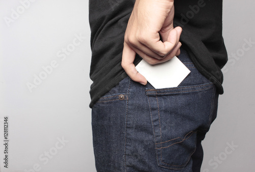 Close up man pulling a card on his back pocket, Blank card with copy space in a pocket of jeans.