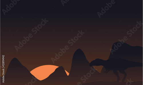 Silhouette of mapusaurus on brown sky landscape