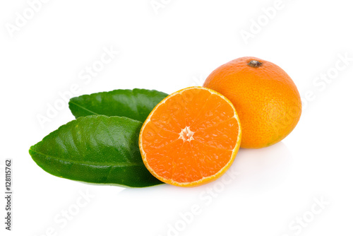Fototapeta Naklejka Na Ścianę i Meble -  whole and cut ripe orange with leaf on white background