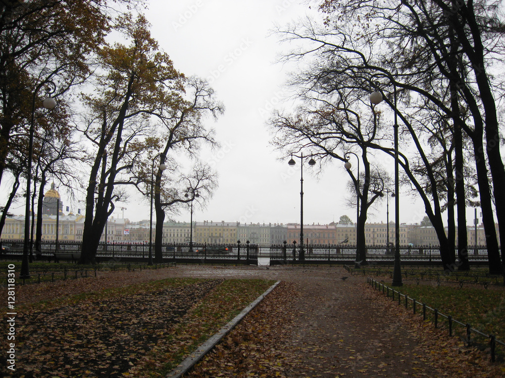 Park at Vasilievsky island Saint-Petersburg, Russia with openwork fence at gloomy day