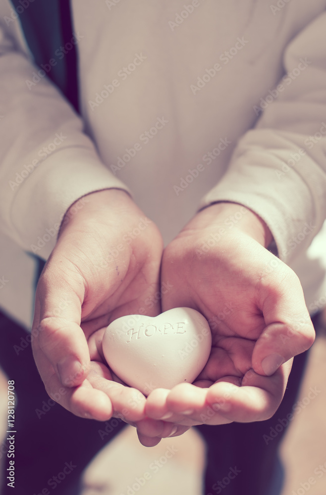 Child hold in hands heart. Text hope Child hold in hands heart. Text hope