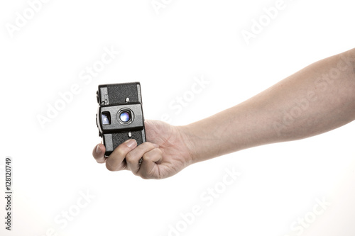 Two hands hold a vintage(old, classic) camera isolated white.  photo