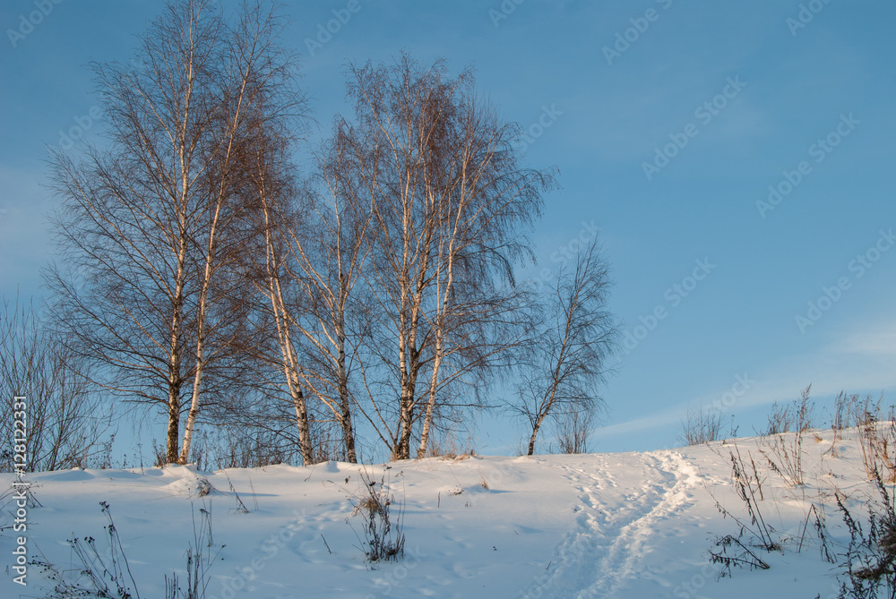 Beautiful winter landscape with snow-covered hills at sunset Beautiful winter landscape with snow-covered hills at sunset