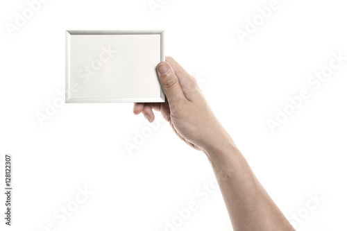 Two hands hold a photo(picture) iron(silver) frame isolated white.