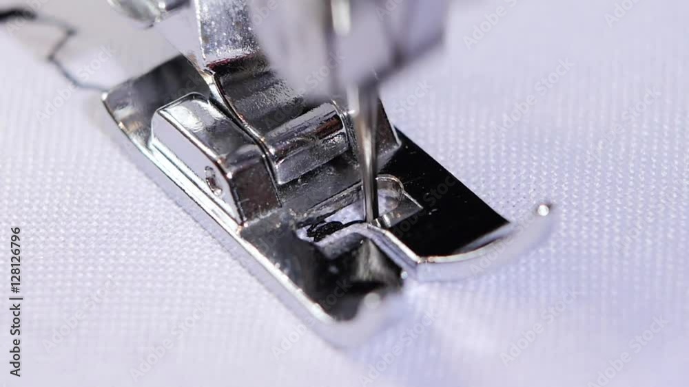 Figured stitch on a white cloth. Sewing machine. Slow motion