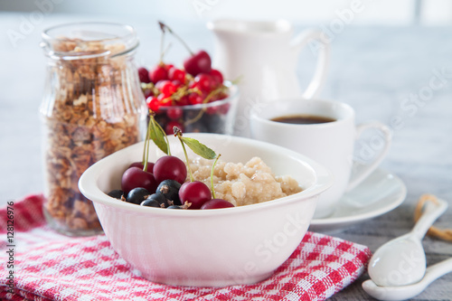 porridge with berries on a table, selective focus