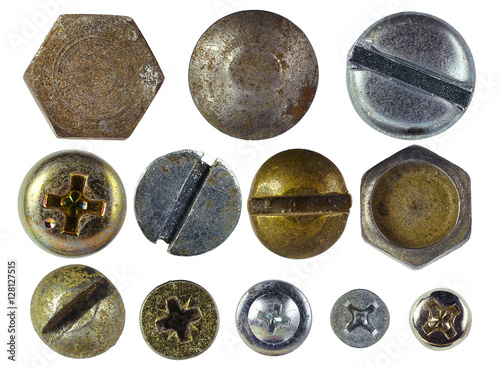 Beautiful textured metal buttons with ornaments and pictures of the silver and gold color close-up macro  isolated on white background.
