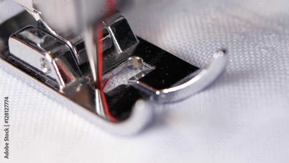 Sewing machine sews a white cloth black thread. Macro Sewing machine sews a white cloth black thread. Macro
