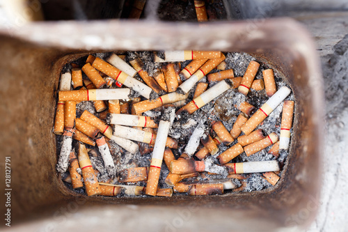 Cigarette butts in trash bin