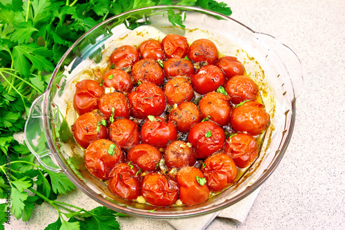 Tomatoes baked in glass pan on table