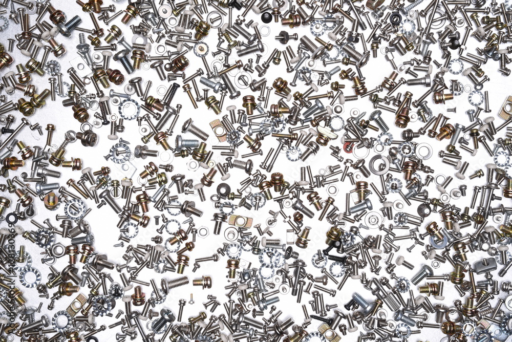 Nuts and bolts on grey metal background Nuts and bolts on grey metal background