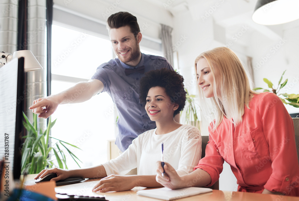 happy creative team with computer in office happy creative team with computer in office