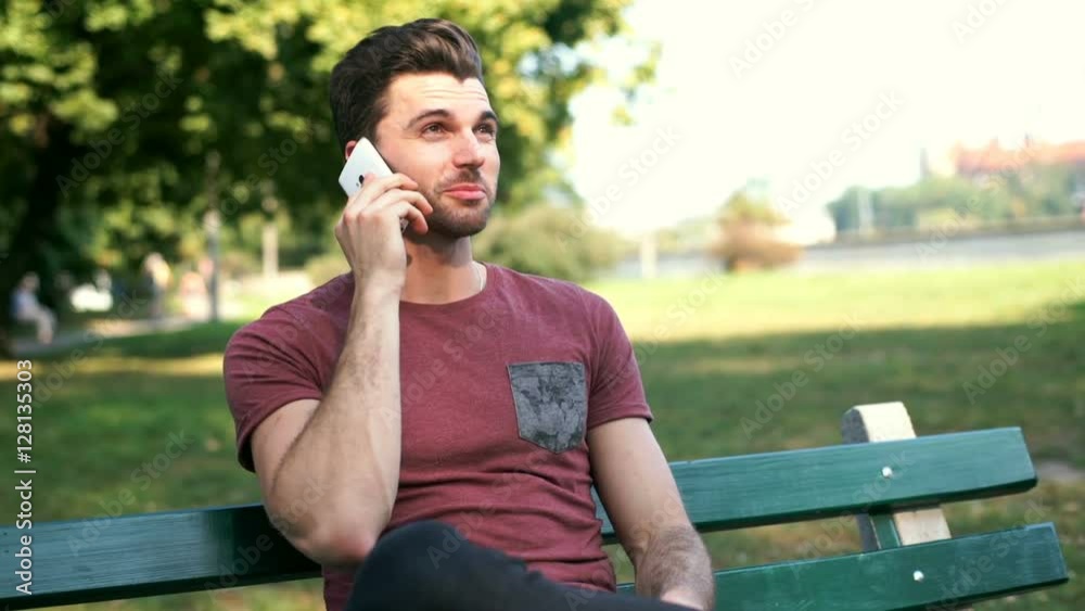 Handsome man finish talking on cellphone while sitting in the park
Handsome man finish talking on cellphone while sitting in the park