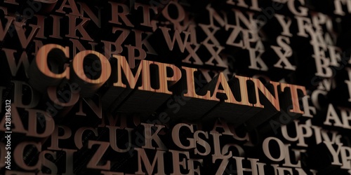 Complaint - Wooden 3D rendered letters message.  Can be used for an online banner ad or a print postcard.