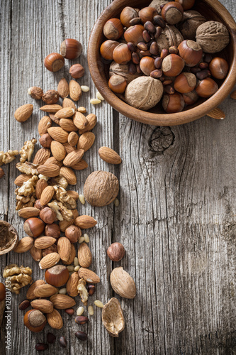 Mixed nuts on old wooden background