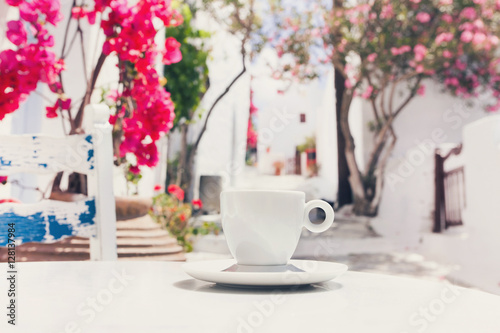 Fototapeta Naklejka Na Ścianę i Meble -  Traditional greek coffee in a cafe with beautiful mediterranean street on the background