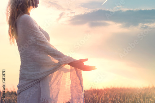 dreamy woman holding the sun in her hands photo
