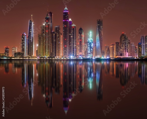 Wallpaper Mural DUBAI, UNITED ARAB EMIRATES - 23 OCTOBER, 2014: Modern night city of Dubai, with reflection on water surface. Tall Dubai Marina skyscrapers as seen from Palm Jumeirah in UAE. Torontodigital.ca