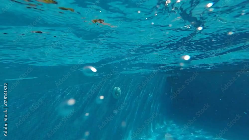 Diving in swimming pool slow motion - blue sky, palm trees and turquoise pool water. Diving in swimming pool slow motion - blue sky, palm trees and turquoise pool water.