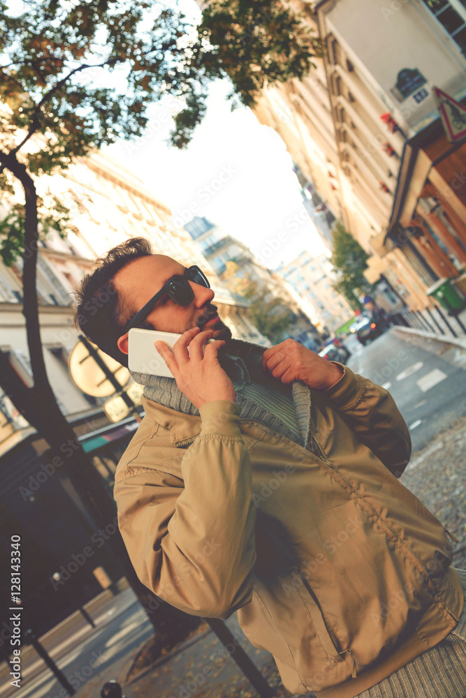 Modern guy using smartphone in the European city.

