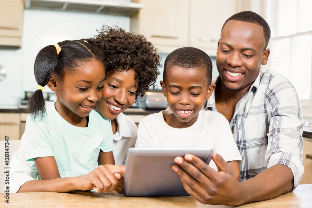 Happy family using tablet in kitchen Happy family using tablet in kitchen