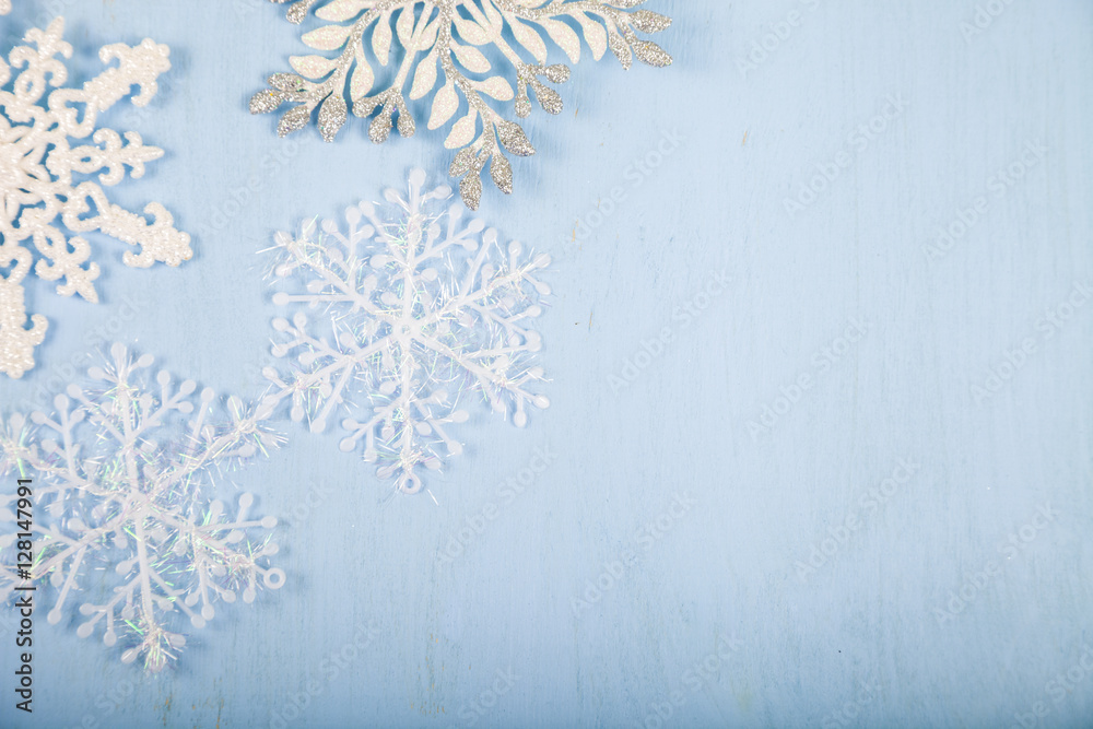 Silver decorative snowflakes on a blue wooden background. Christ Silver decorative snowflakes on a blue wooden background. Christ