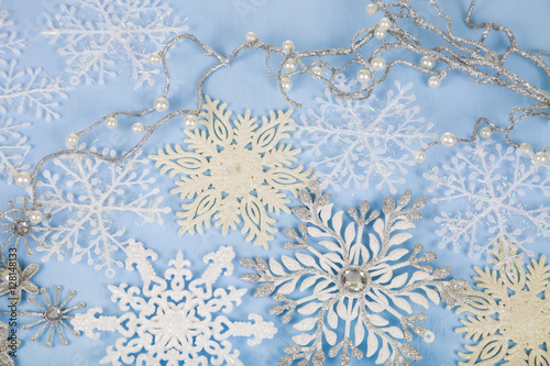 Silver decorative snowflakes on a blue wooden background. Christ