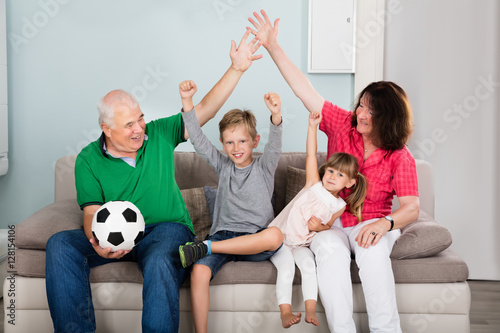 Family Watching Football Match On Television