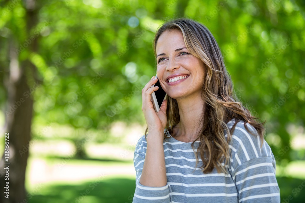 Smiling woman making a phone call Smiling woman making a phone call